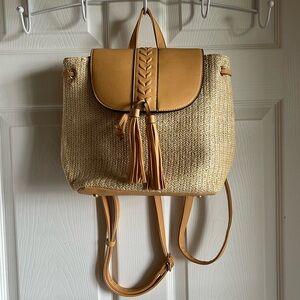 Women’s faux straw/leather backpack.